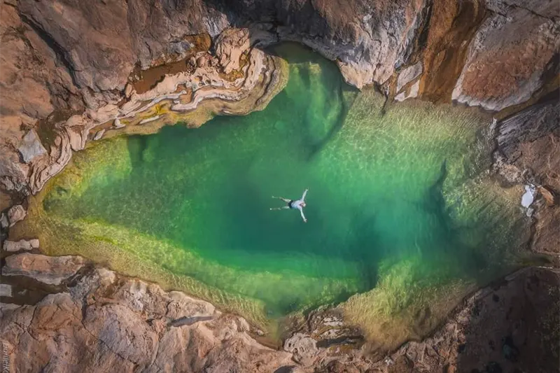 man swimming in a secret pool